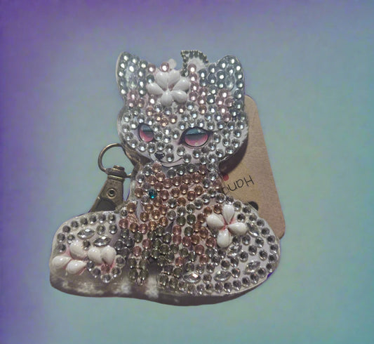 Decorative bow with rhinestones on a light fabric background