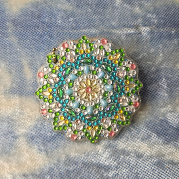 Decorative brooch on a textured fabric background