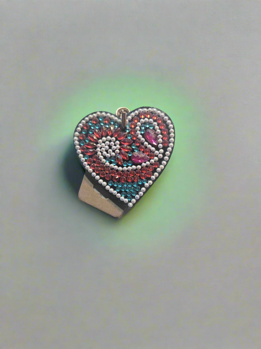 Beaded heart-shaped object on a light fabric background
