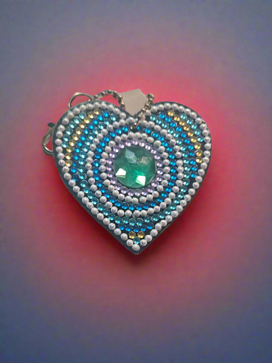 Beaded ring with blue and silver design on a light gray background