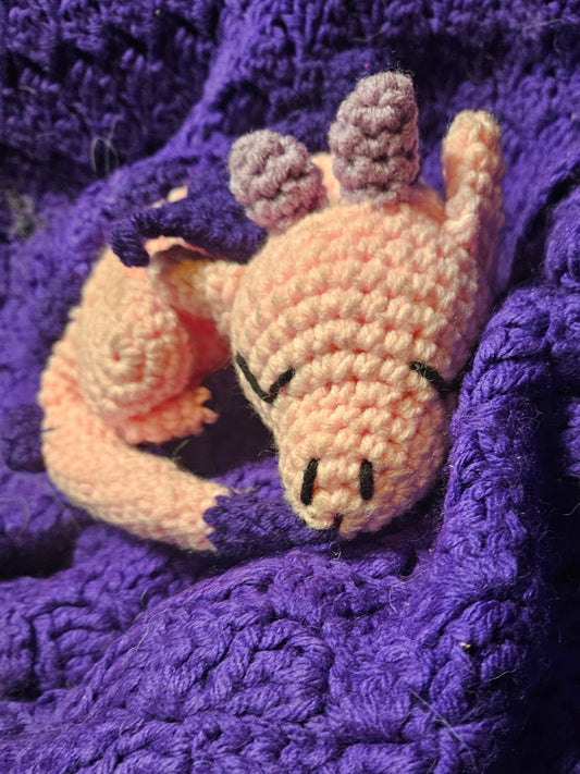 Crocheted dog toy on a purple textured fabric background