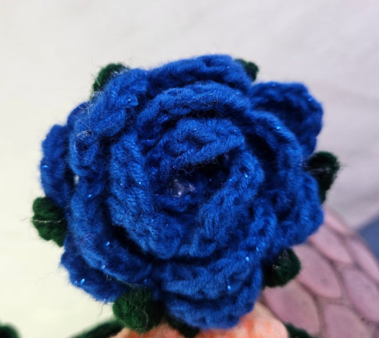 Blue crocheted flower on a white background