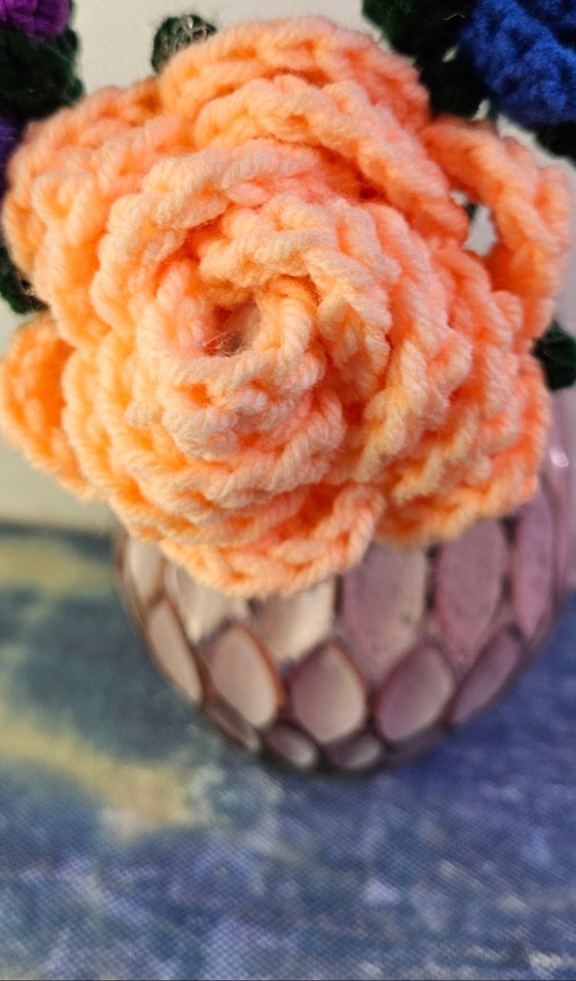 Colorful crocheted flowers on a textured surface