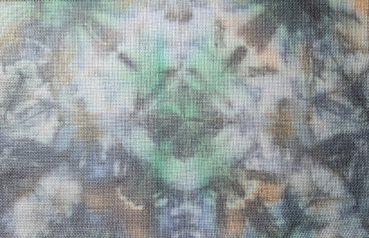 A rectangular woven fabric panel with an abstract tie-dye style pattern in shades of blue, green, beige, and gray, laid flat on a patterned beige surface.