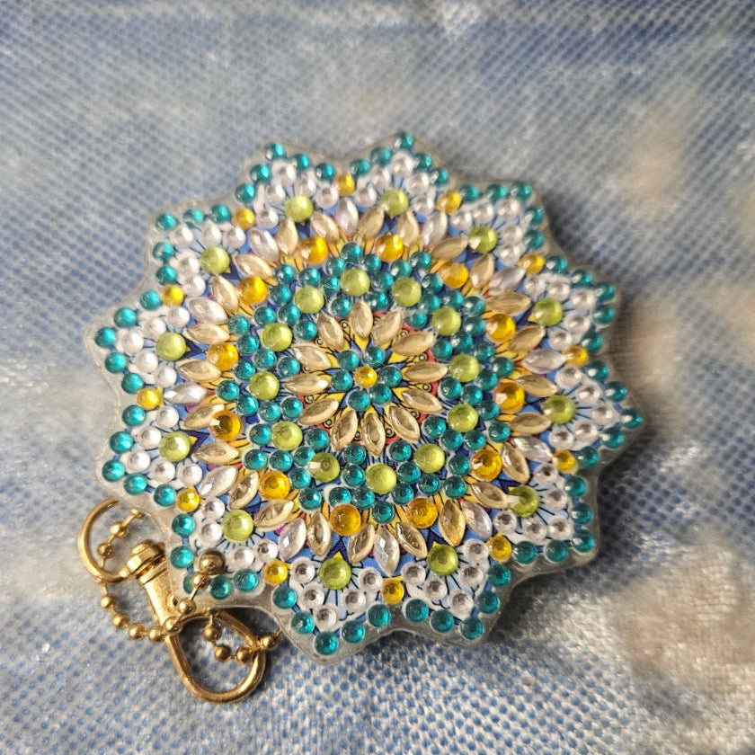 Decorative brooch with bead pattern on a textured fabric background